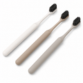 White beige and grey bamboo leaf design hotel toothbrushes on white background