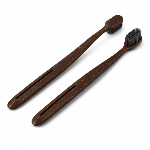 Eco-friendly coffee husk hotel toothbrushes with bamboo charcoal bristles on white background