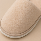 close up of soft coral fleece hotel slippers texture showing premium material