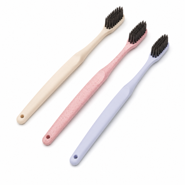 European style disposable hotel toothbrushes with soft charcoal bristles on white background