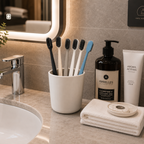 Disposable hotel toothbrushes displayed in a luxury hotel bathroom