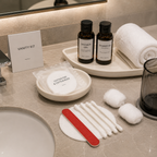 hotel vanity kit with cotton pads displayed in modern bathroom