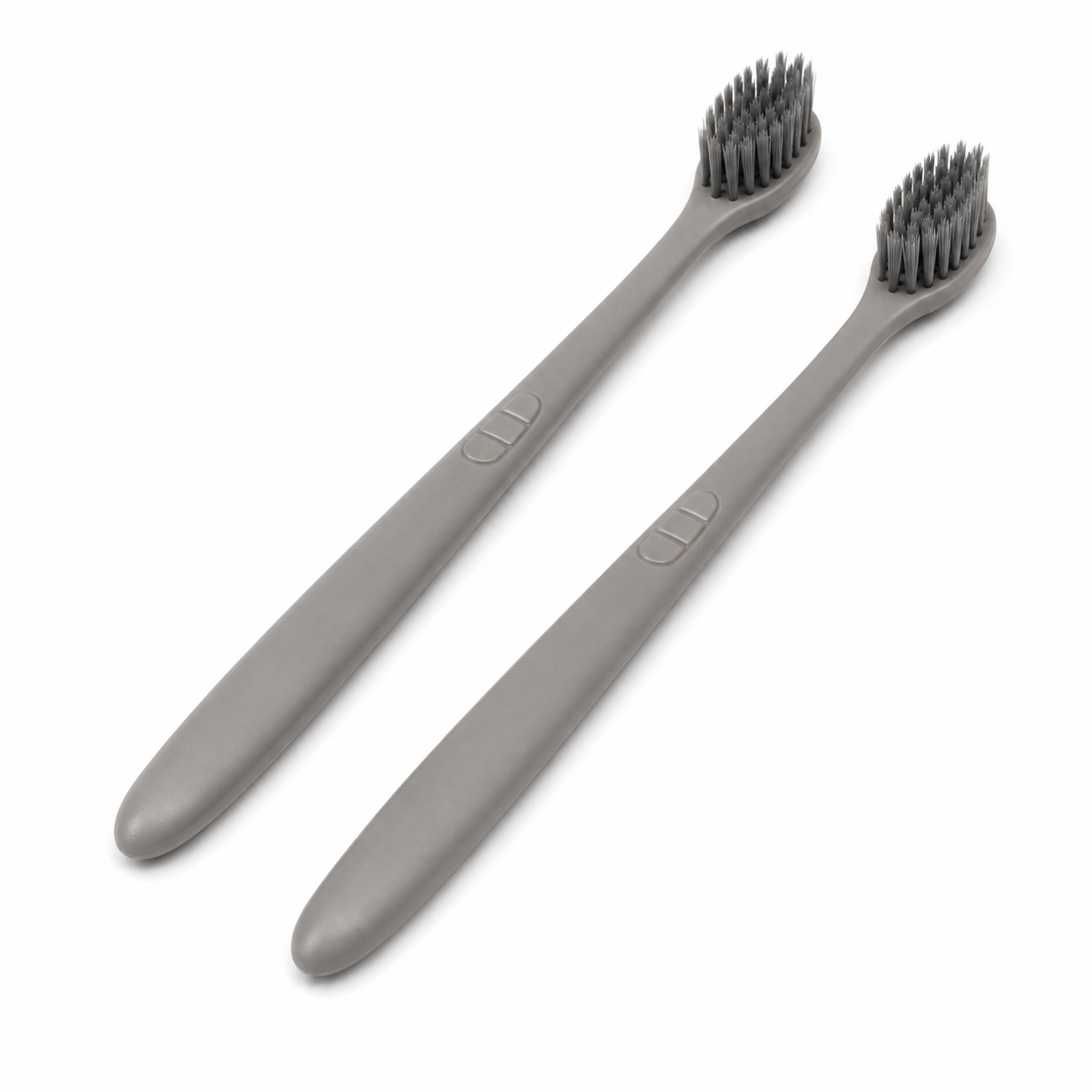 Minimalist grey hotel toothbrushes with soft bamboo charcoal bristles on white background