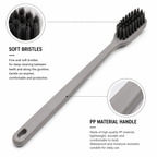 Close-up detail of PP hotel toothbrush handle and soft charcoal bristles