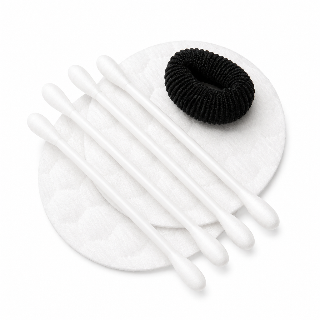 cotton pads cotton swabs and black hair tie for hotel vanity kit