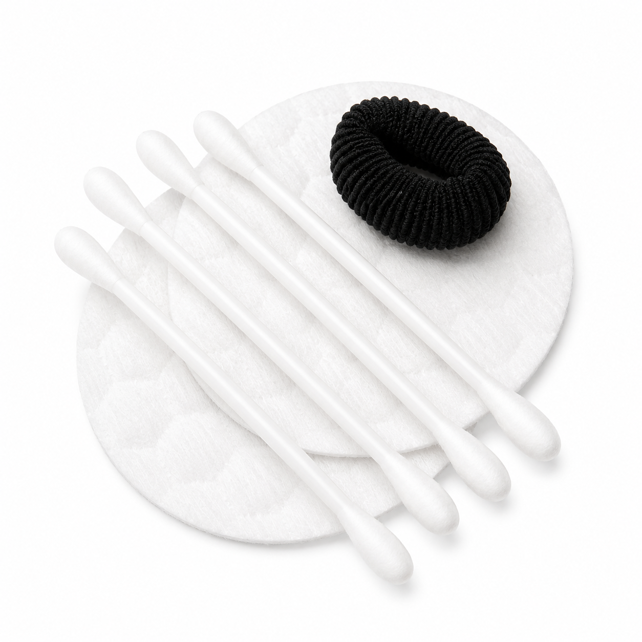 cotton pads cotton swabs and black hair tie for hotel vanity kit