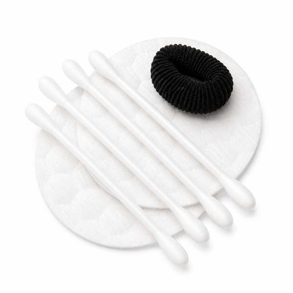 cotton pads cotton swabs and black hair tie for hotel vanity kit