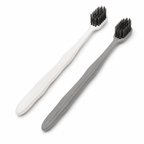 Grey and white hotel toothbrushes with ergonomic wavy anti-slip handles on white background